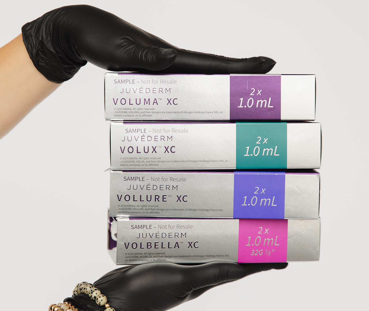Stacked boxes of Volbella XC dermal filler with syringe on top.