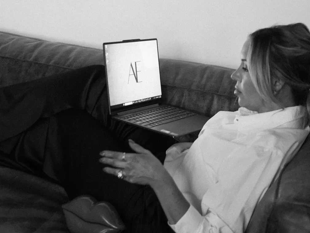 Person relaxing on a couch with a laptop.